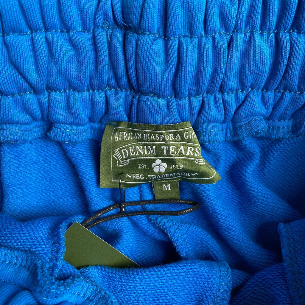 DENIM TEARS COTTON WREATH SWEATPANTS AZURE BLUE - netstar